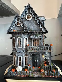 a halloween house with pumpkins and decorations on it