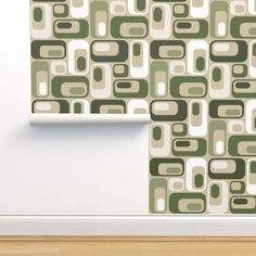 an abstract wallpaper design with green and white squares on the wall next to a wooden floor