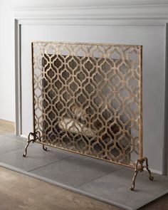 a fireplace screen sitting on top of a tile floor