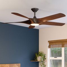 a bed room with a neatly made bed and a ceiling fan in the middle of it