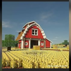 a large red barn sitting in the middle of a field with lots of yellow grass