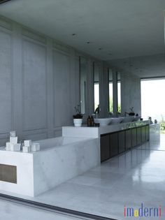 a large bathroom with two sinks and mirrors