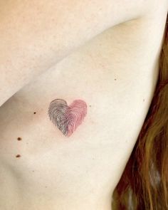 a close up of a woman's chest with a fingerprint in the shape of a heart