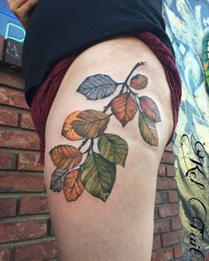 a woman's thigh with leaves painted on it