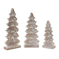 three wooden christmas trees sitting next to each other