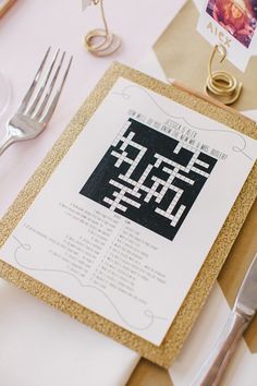 a close up of a menu on a table with silverware and utensils