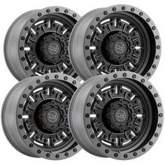 four black and chrome wheels on white background