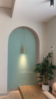 an arched doorway with a potted plant in the center and a light on above it