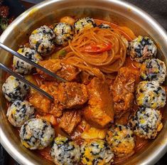 a bowl filled with pasta and meatballs