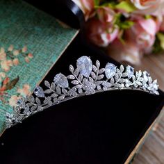 a tiara sitting on top of a table next to flowers