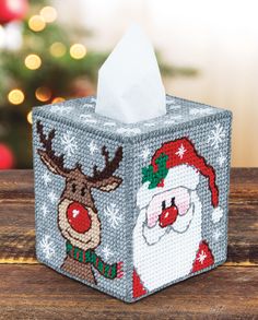 a christmas themed tissue box on a wooden table