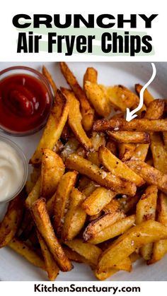 a white plate topped with french fries next to ketchup and mayonnaise