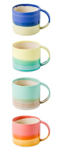 three different colored mugs stacked on top of each other