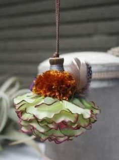 an ornament hanging from a rope next to a potted plant