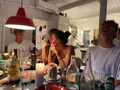 a group of people sitting around a dinner table