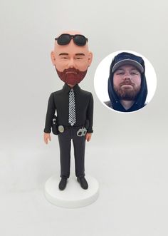 a custom bobble head with a man in a suit and tie on top of it