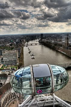 an image of london eye taken from the top of one of the buildings on the river thames