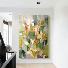 a painting hanging on the wall next to a stair case in a house with white walls