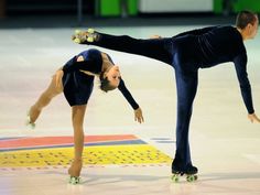 two people on skates doing tricks in an indoor skating rink