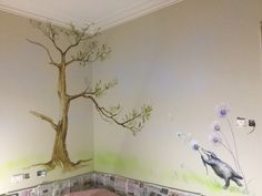 a bedroom with a tree painted on the wall