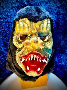 a close up of a person wearing a mask with teeth and fangs on their face