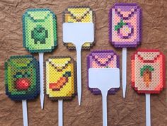 six lollipops made out of lego blocks on a brown surface with white handles