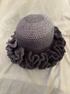 Ruffle hat, variegated yarn, so each hat is different. Fits most women from a smoke-free home. Very stylish and unique hat perfect for any occasion. Hand Knitted Sun Hat One Size Fits Most, Gray Crochet Hat, One Size Fits Most, Yarn Cloche Hat One Size Fits Most, Gray Crochet Hat One Size, Yarn Hat With Curved Brim, One Size Fits Most, Curved Brim Yarn Hat One Size, Curved Brim Hats In Yarn, One Size, Wide Brim Yarn Mini Hats, Gray Hand Knitted Hat, One Size Fits Most