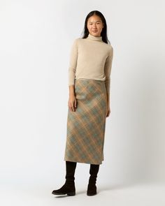 The Marina Skirt is constructed with a slim A-line fit and midi-length hem. This one’s made up in a rich plaid wool from England and finished with a discreet side-zip closure — just add a turtleneck and boots and your look is done. Fitted Brown Wool Skirt, Plaid Tan Skirt, Plaid Skirt Knit Sweater, Wool Plaid Skirt, Plaid Midi Skirt With Lined Detail, Clothing Catalog, Buckle Shoes, Sweater Gift, Liberty Fabric