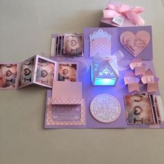 an assortment of items displayed on a table with pink bows and tags around them,