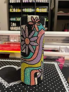 this is an image of a vase made out of beads