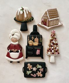 christmas cookies are arranged in the shape of houses and other decorations on a white surface