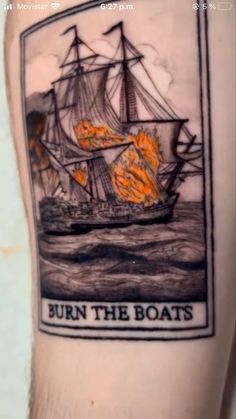 a man's arm with a burning ship on it and the words burn the boats