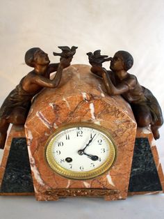 a marble clock with three children on it