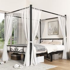 a canopy bed with white drapes and curtains