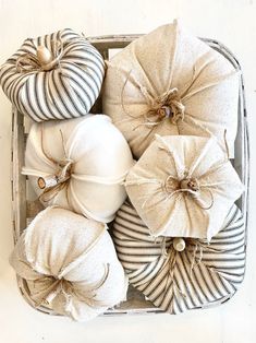 white and black decorative pillows in a basket