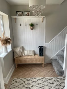 the entryway is clean and ready for guests to come home with their belongings on the bench