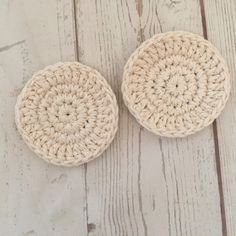 two crocheted bowls sitting on top of a white wooden floor next to each other