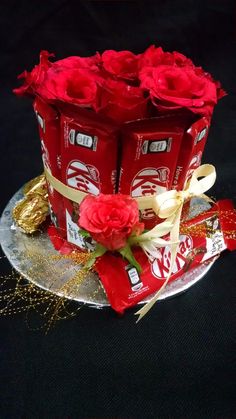 a cake decorated with roses and chocolate bars