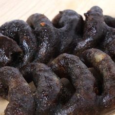 several pieces of chocolate covered doughnuts on a cutting board