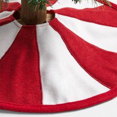 a red and white striped christmas tree skirt