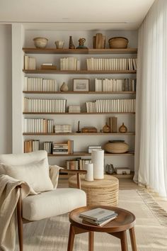 a living room filled with furniture and bookshelves next to a wall full of shelves