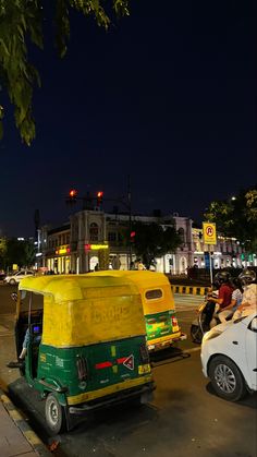 an auto rickshaw is parked on the side of the road