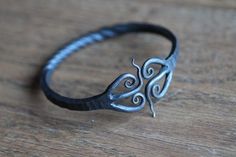 a silver ring sitting on top of a wooden table