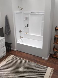 a white bath tub sitting on top of a wooden floor