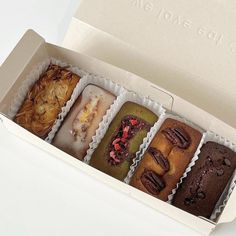 four different types of donuts in a box