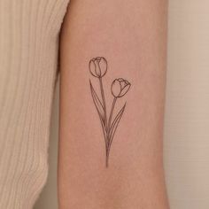 a single flower tattoo on the left arm