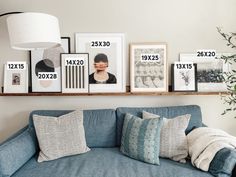 a blue couch sitting next to a wooden shelf filled with pictures