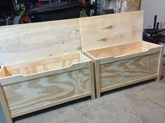 two wooden boxes sitting next to each other on top of a floor in a garage