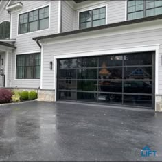 Double glass garage door with black frame and gray tinted glass panels by ProLift Garage Doors Black Glass Garage Door White House, Glass Panel Garage Door, Double Garage Door Ideas Modern, Transparent Garage Door, Black Glass Garage Door, Garage Doors White, Double Garage Doors, Bath University, Folding Garage Doors