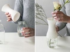 two hands are holding vases with flowers in them and one is holding a flower